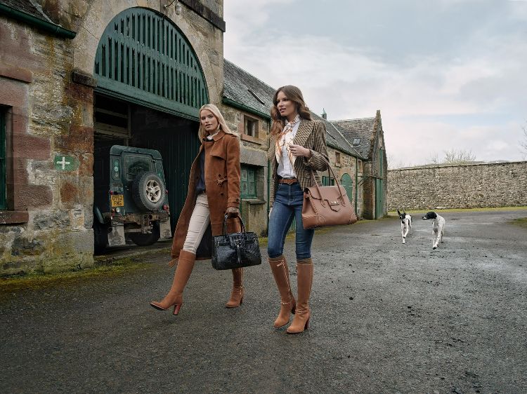 Two women walking together wearing Fairfax & Favor country footwear